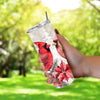 a hand holding a cup with a red bird on it